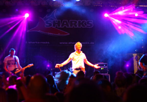SHARKS auf der Bühne. Der Sänger der Band SHARKS auf einer Bühne in blauem ind violetten Licht